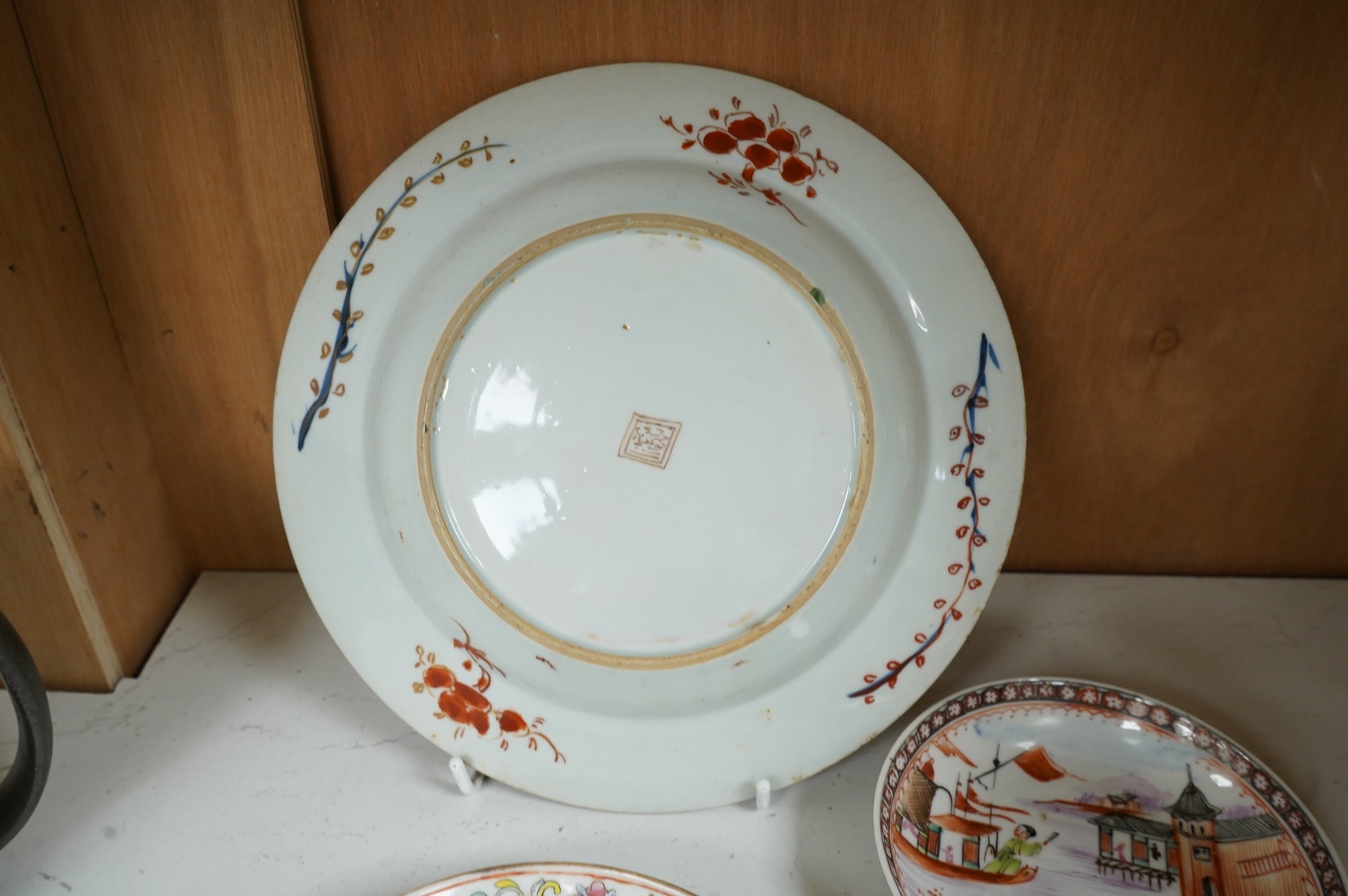 An 18th century Chinese clobbered dish, a famille rose dish, Guangxu six character mark and two 18th century Chinese export saucers, largest 22cm